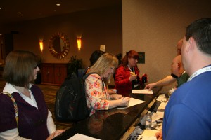 Mary Jo Boyd, Cathy Prichard and Sheryn Bruehl get ready to start the conference.